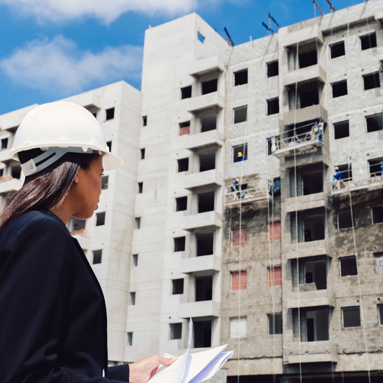 african-american-lady-safety-helmet-with-papers-near-building-construction-edited